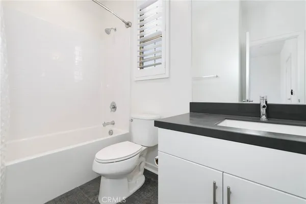 a view of a patio with couches table and chairs with potted plants