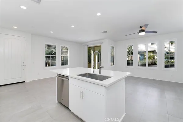 a kitchen with stainless steel appliances kitchen island granite countertop a stove a sink and a refrigerator