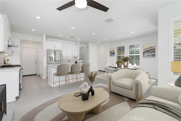 a view of a kitchen with kitchen island a sink stainless steel appliances and counter space