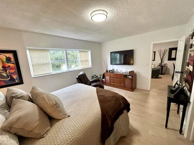 a bedroom with furniture and a flat screen tv