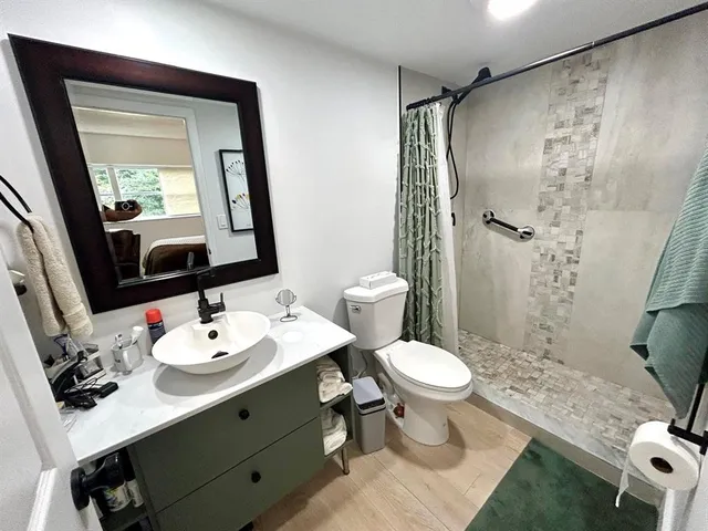 a bathroom with a sink toilet and shower