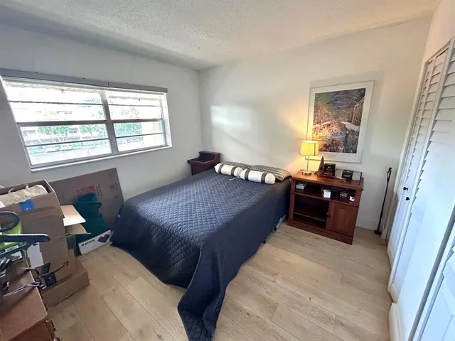 a bed room with a bed and a chair