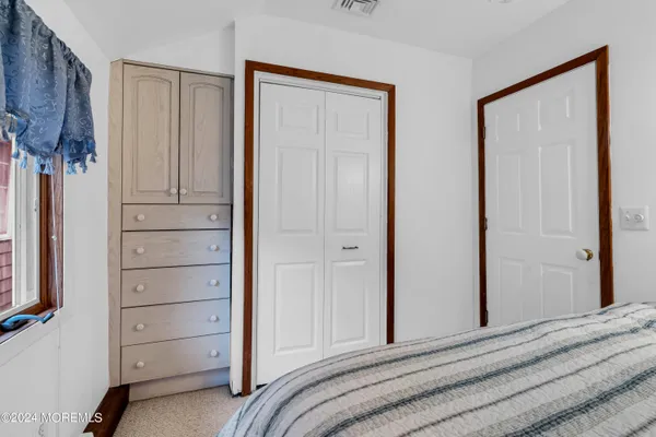 a bedroom with a bed and a closet