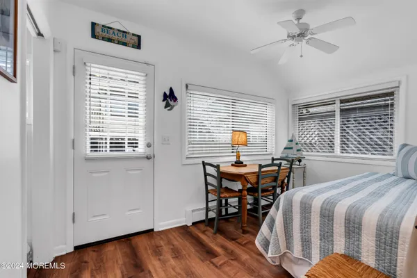 a bedroom with a bed and a table chair