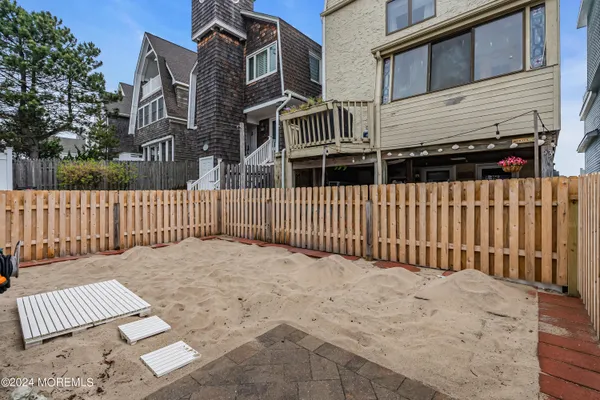 a view of a brick house with wooden fence
