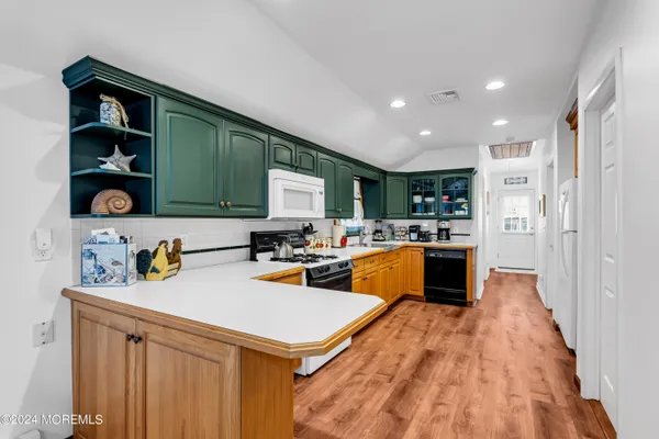 a kitchen with stainless steel appliances granite countertop a sink a stove and a refrigerator