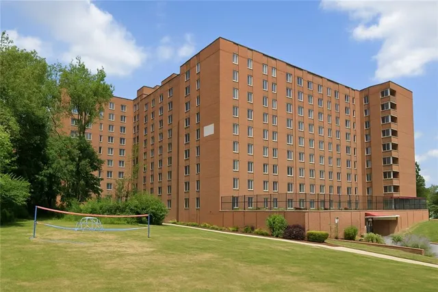 a large building with a swimming pool in front of it