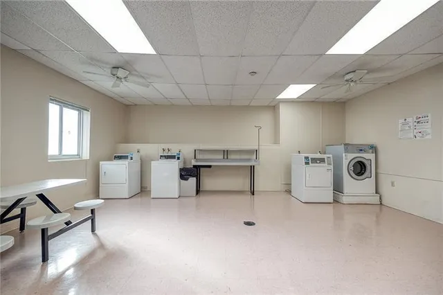 a view of a storage & utility room with two washing machine