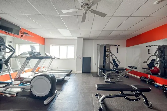 a room with gym equipment and mirror