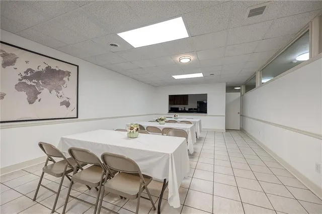 a view of a dining room with furniture and a kitchen