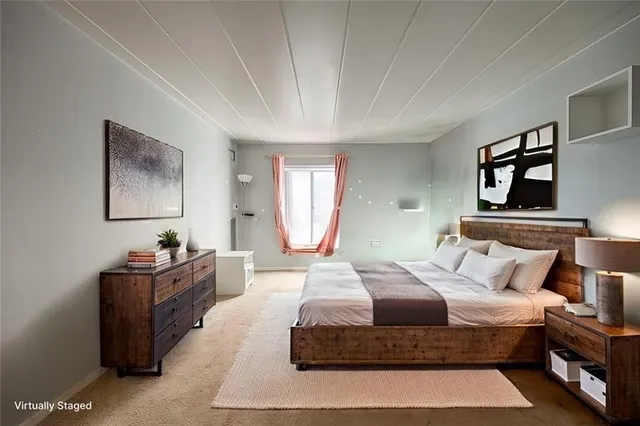 a bedroom with a large bed and a chandelier