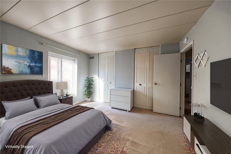 5 Bayard Road, Unit 309 Pittsburgh, PA 15213 - Photo 5 of 19 a spacious bedroom with a bed and a flat screen tv