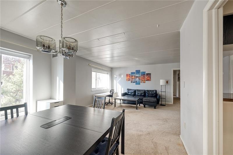 5 Bayard Road, Unit 309 Pittsburgh, PA 15213 - Photo 8 of 19 a living room with furniture and a chandelier