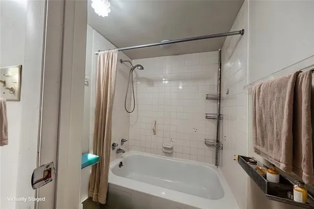 a bathroom with a shower and a bathtub