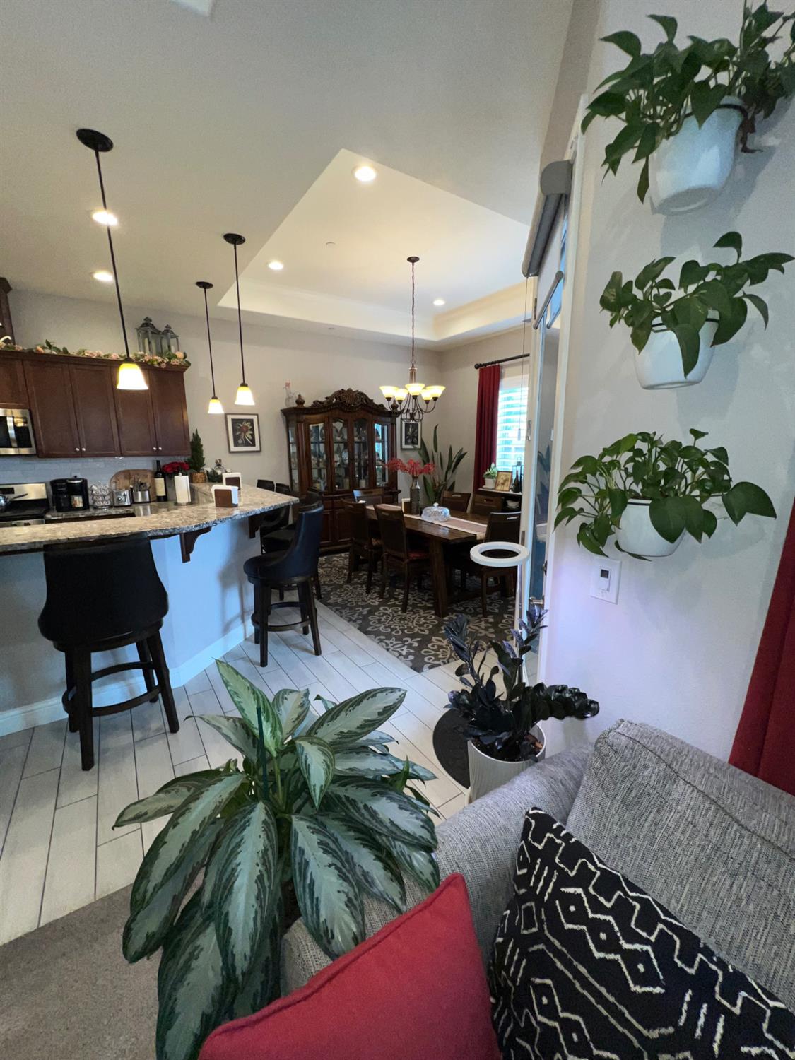 889 Coloma Place Madera, CA 93637 - Photo 10 of 61 a living room with furniture flowers and a chandelier
