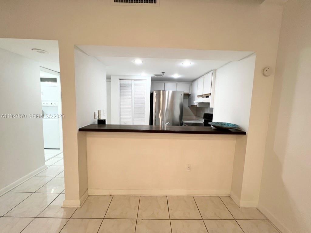 540 Brickell Key Drive, Unit 214 Miami, FL 33131 - Photo 4 of 48 a view of a refrigerator in kitchen and an empty room