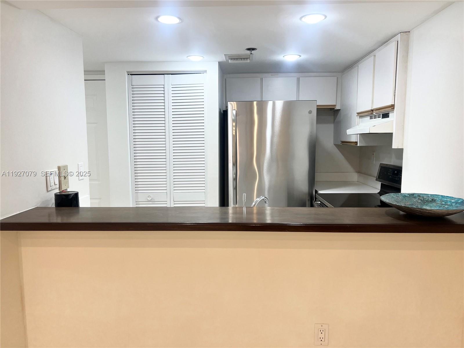 540 Brickell Key Drive, Unit 214 Miami, FL 33131 - Photo 6 of 48 a kitchen with stainless steel appliances granite countertop a sink and a refrigerator