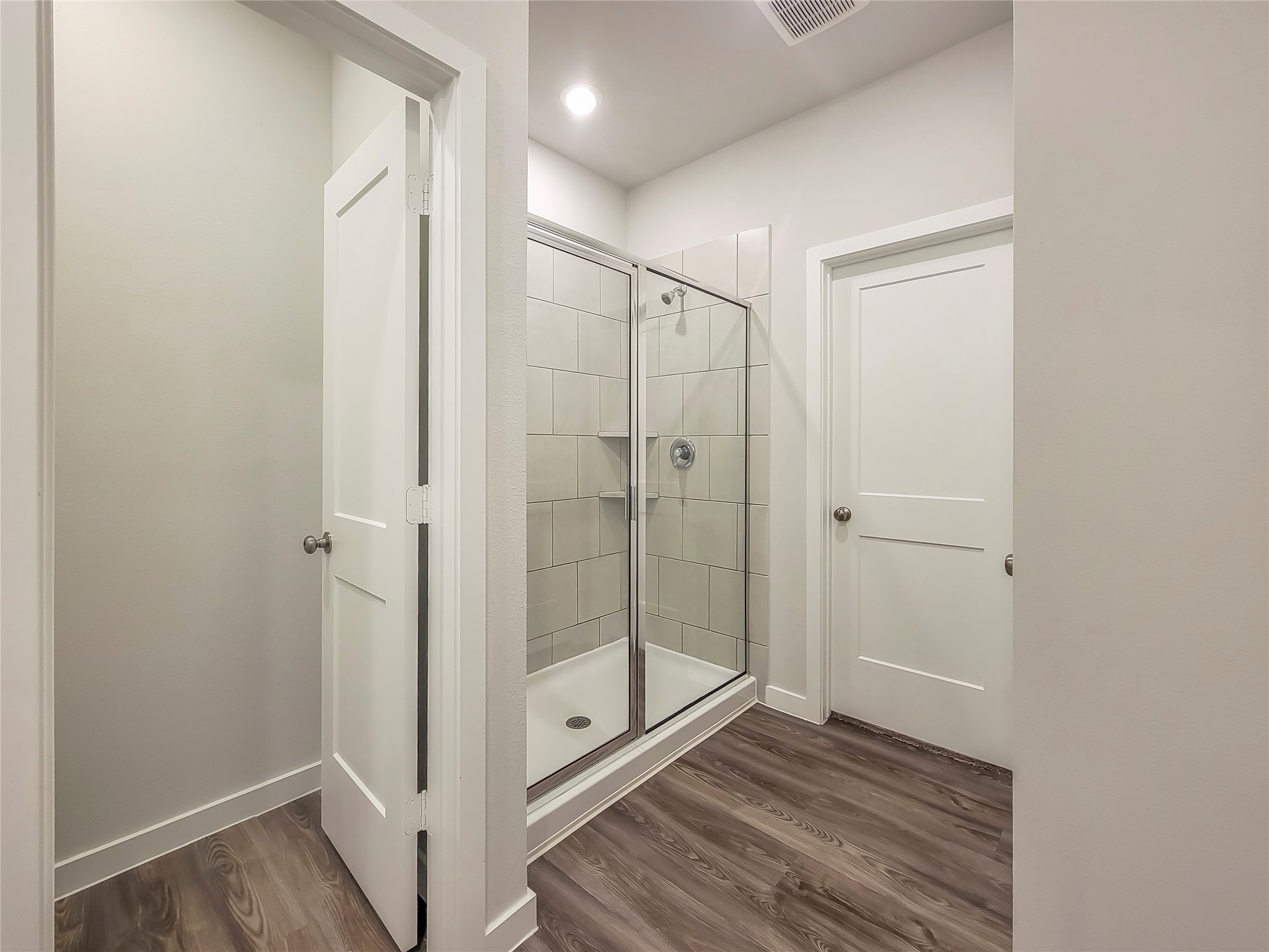 16983 Pandora Way Porter, TX 77365 - Photo 11 of 17 a bathroom with a glass shower door