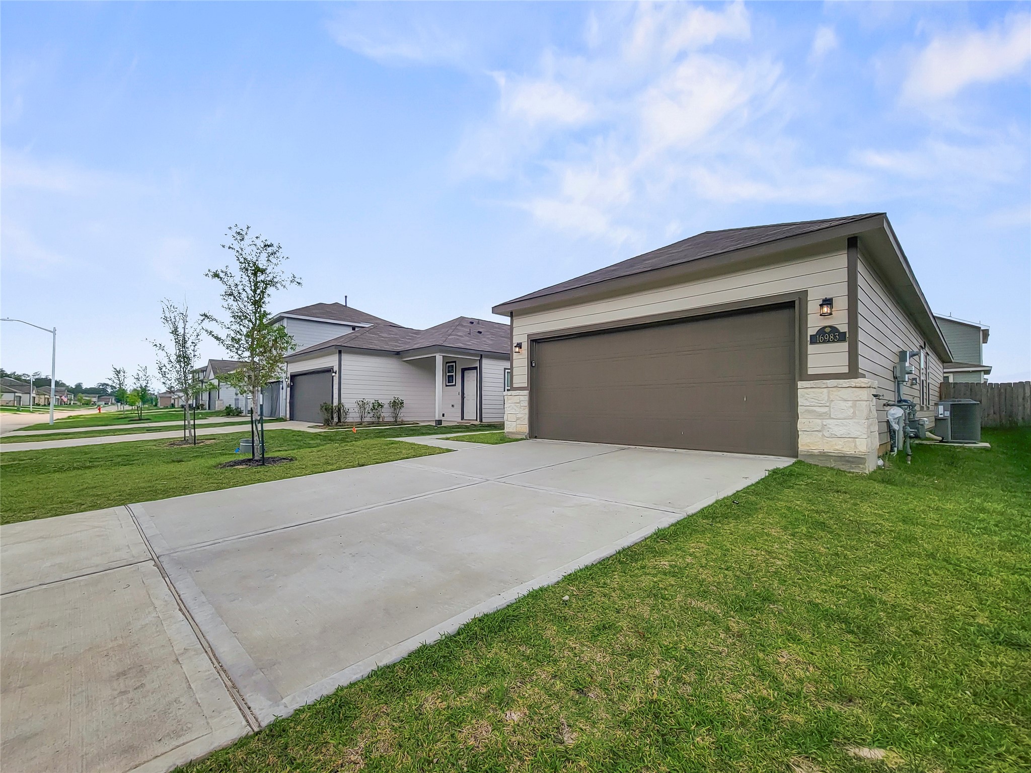 16983 Pandora Way Porter, TX 77365 - Photo 14 of 17 a front view of a house with a yard