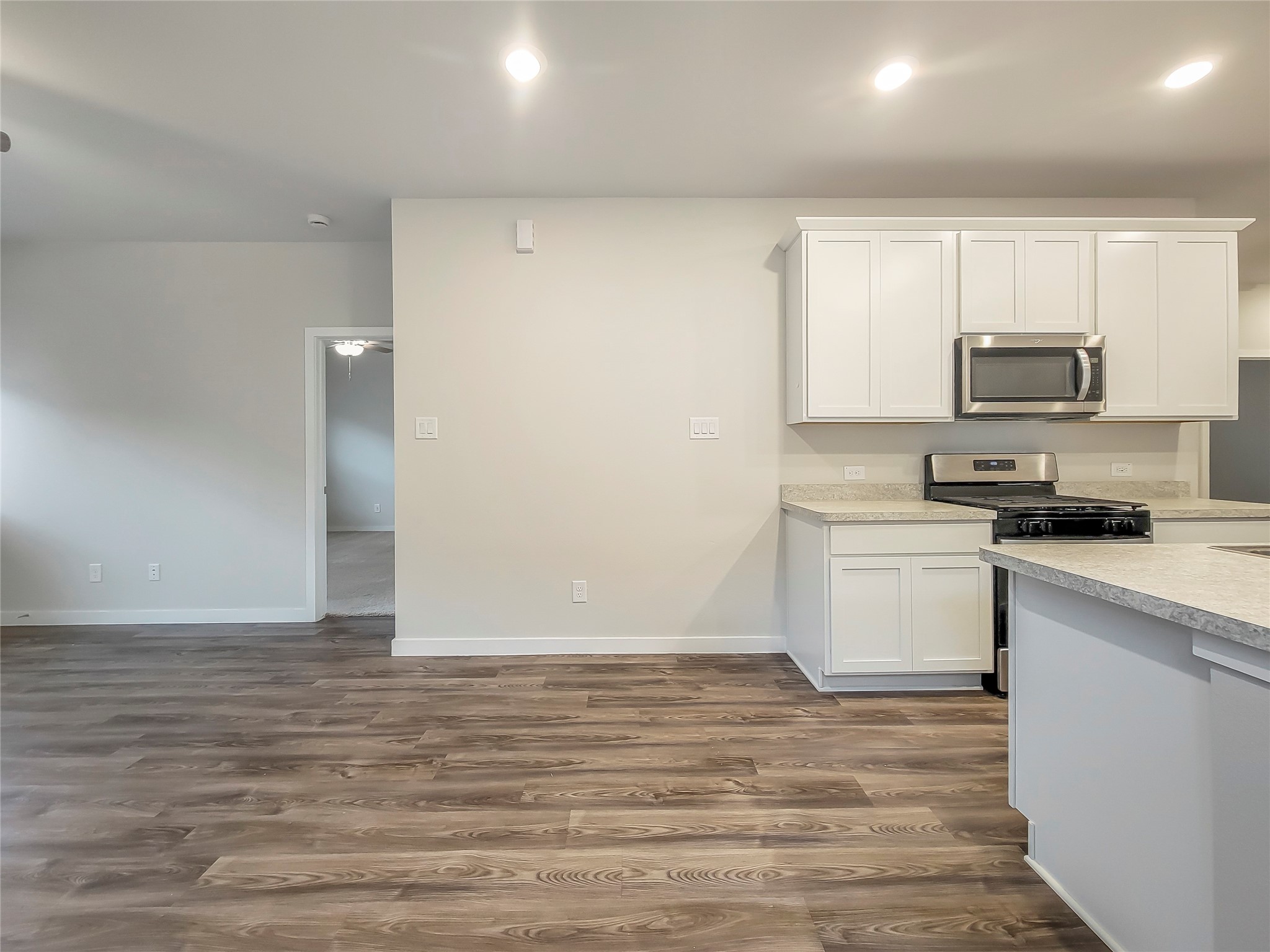 16983 Pandora Way Porter, TX 77365 - Photo 2 of 17 a view of kitchen with microwave and stove