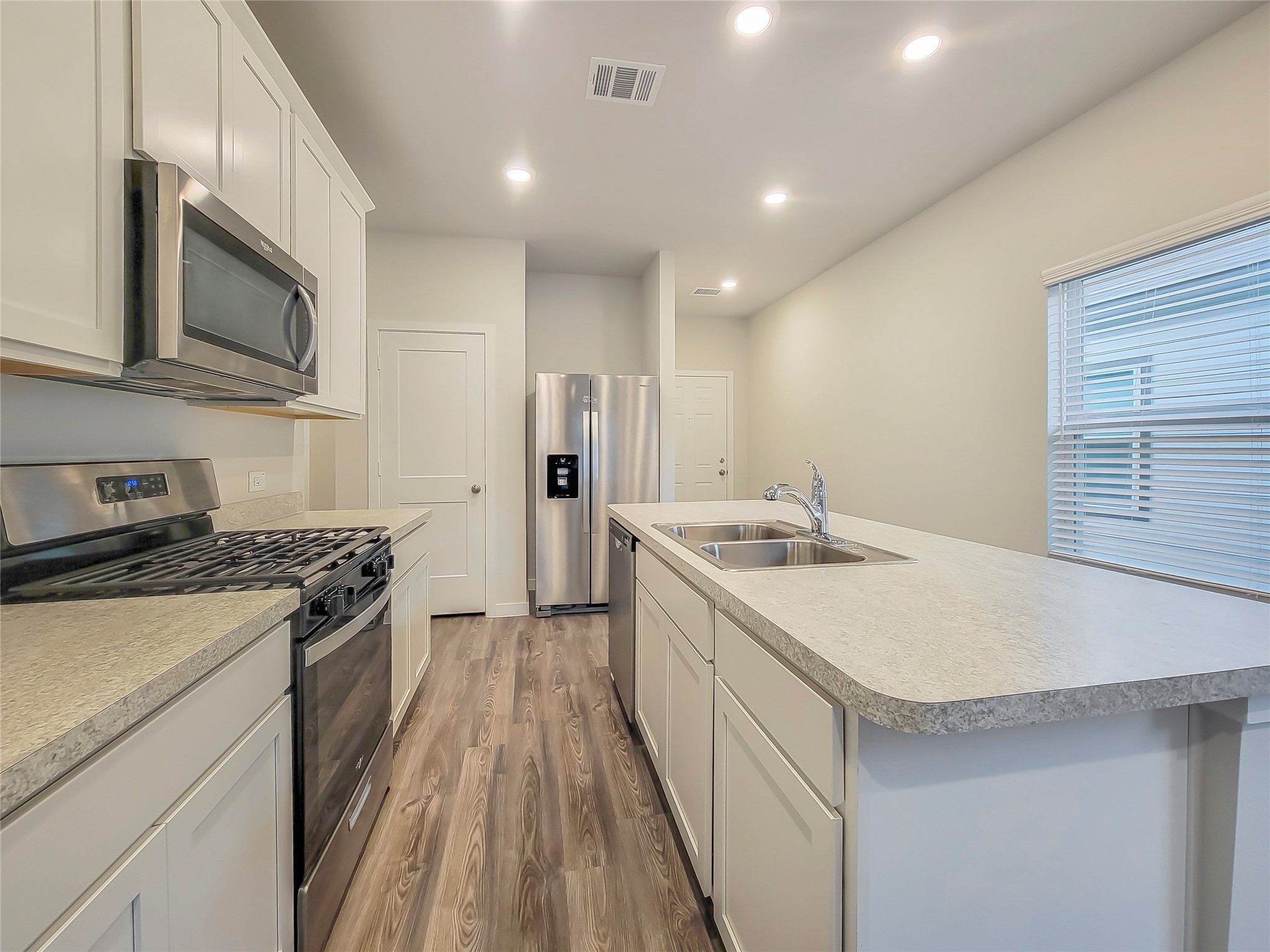 16983 Pandora Way Porter, TX 77365 - Photo 3 of 17 a kitchen with a sink stove and refrigerator