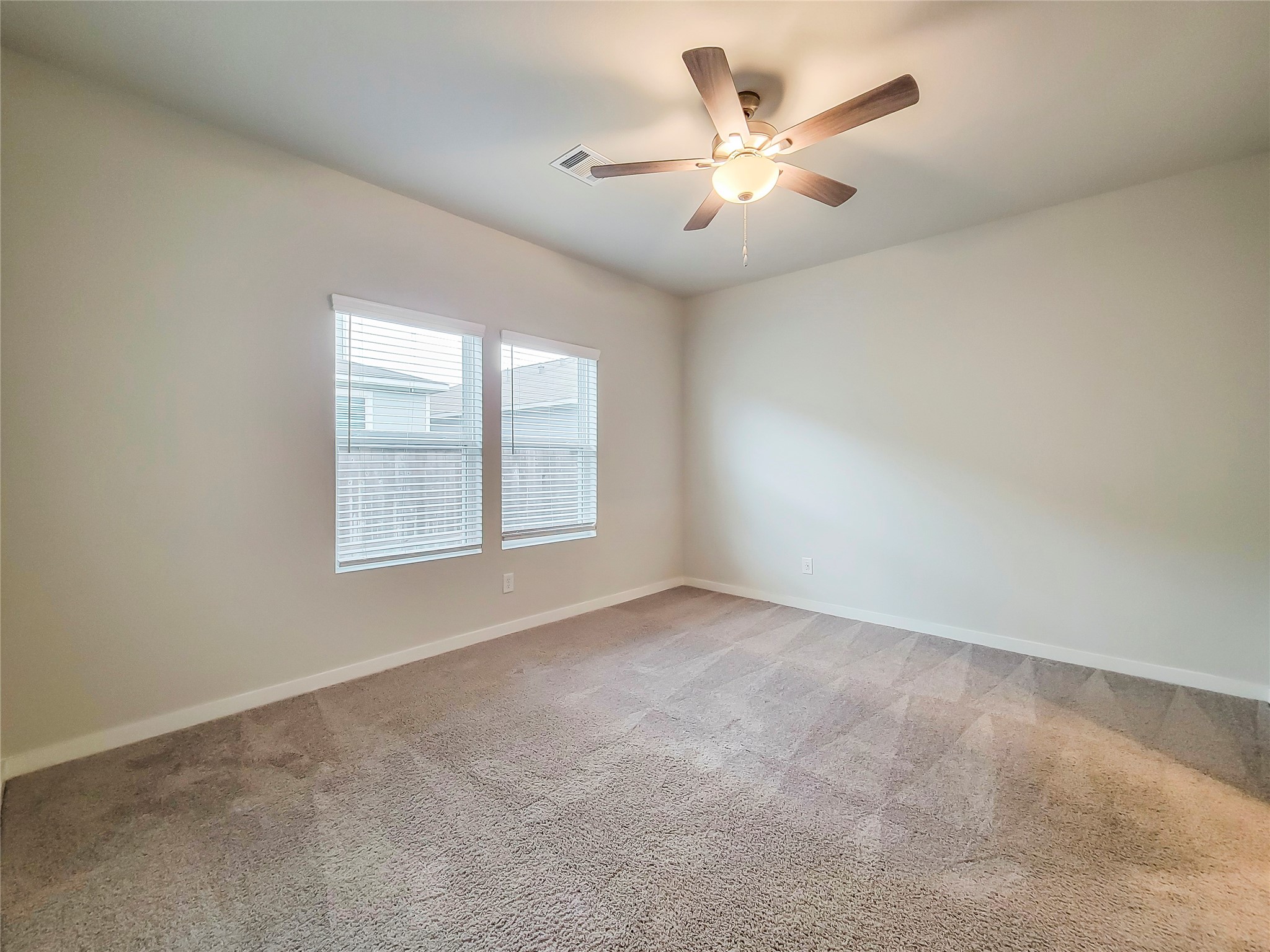 16983 Pandora Way Porter, TX 77365 - Photo 5 of 17 an empty room with windows and ceiling fan