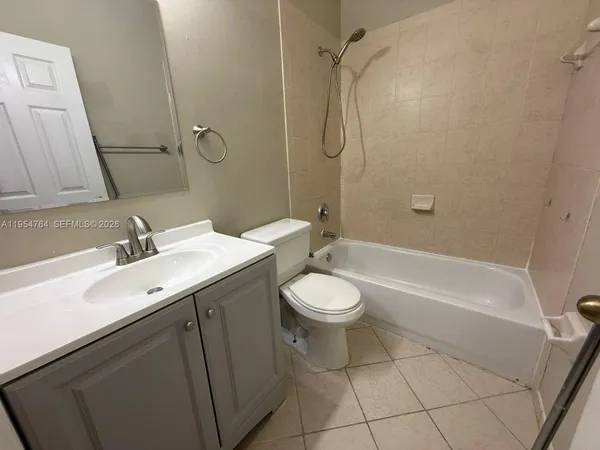 an empty room with wooden floor and window