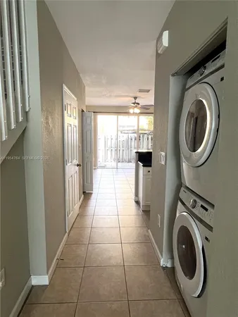 a view of backyard with tub and door