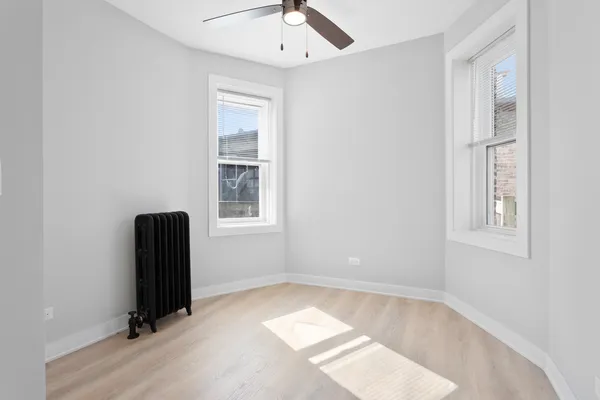 an empty room with windows and closet