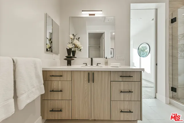 a bathroom with a sink vanity and a mirror