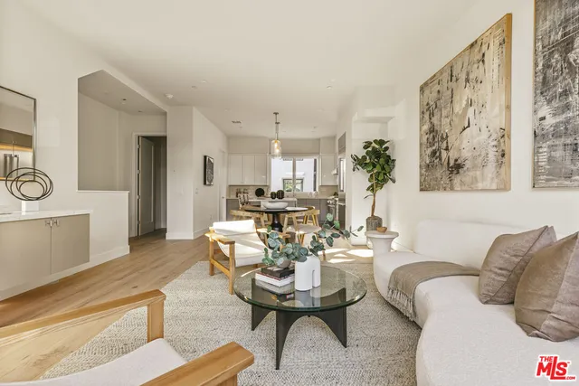a living room with furniture a large window and a table