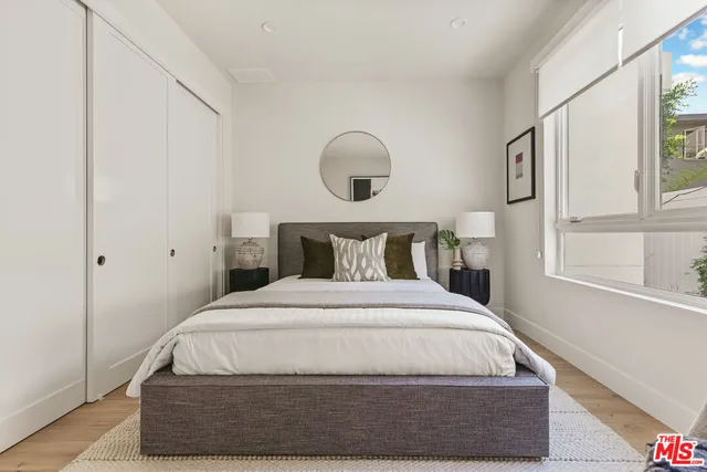 a bedroom with a bed and window