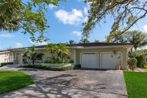 a view of a house with a yard and a garage
