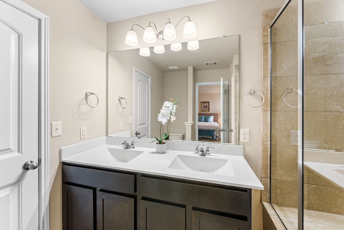 408 Cane River Road Pflugerville, TX 78660 - Photo 18 of 38 a bathroom with a sink double vanity and a mirror