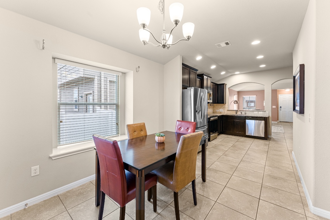 408 Cane River Road Pflugerville, TX 78660 - Photo 22 of 38 a view of a dining room with furniture and a chandelier