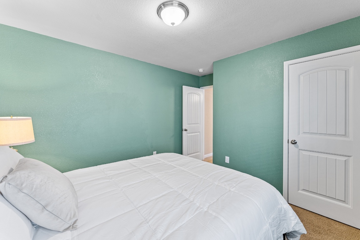 408 Cane River Road Pflugerville, TX 78660 - Photo 24 of 38 a bedroom with a bed and a window