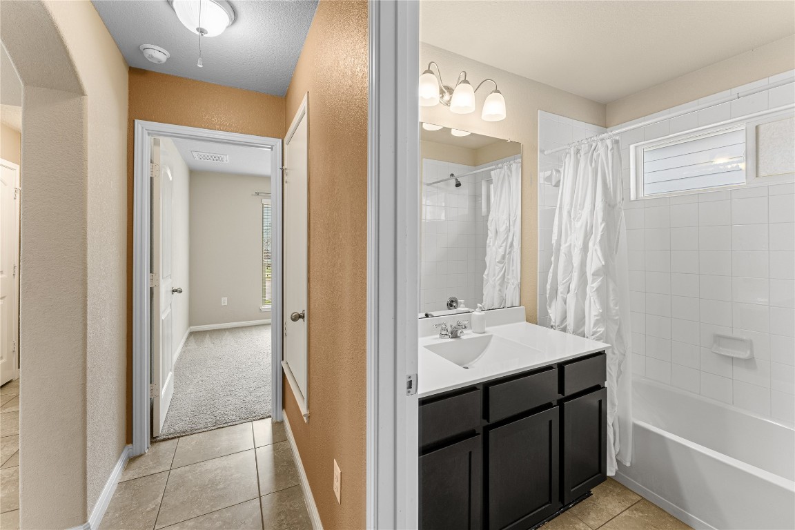 408 Cane River Road Pflugerville, TX 78660 - Photo 25 of 38 a bathroom with a sink a mirror and a shower