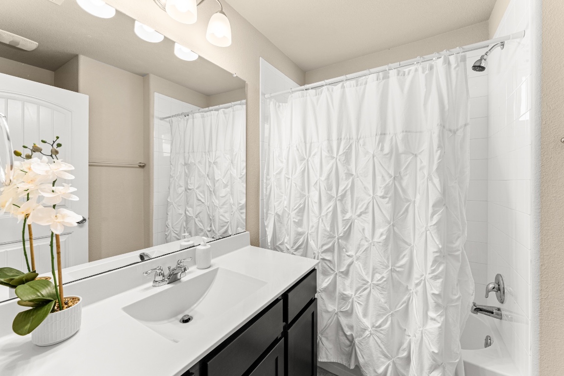 408 Cane River Road Pflugerville, TX 78660 - Photo 26 of 38 a bathroom with a sink and a mirror