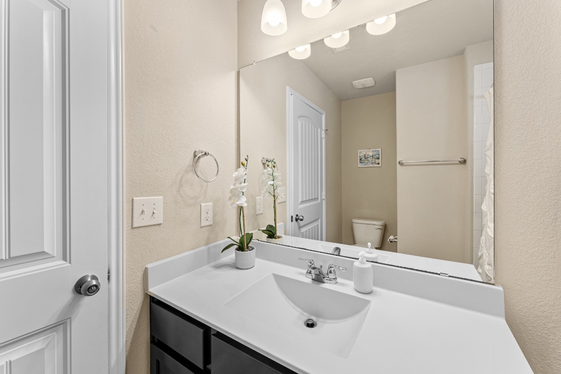 408 Cane River Road Pflugerville, TX 78660 - Photo 27 of 38 a bathroom with a sink vanity and a mirror