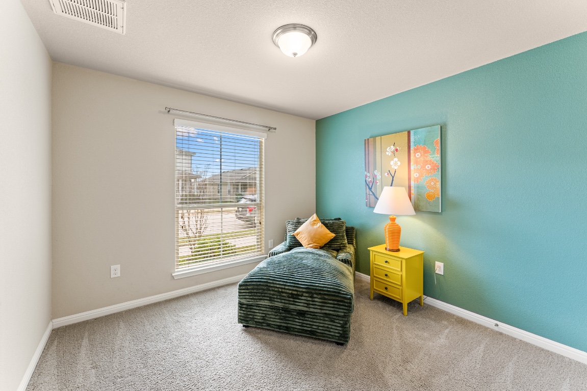 408 Cane River Road Pflugerville, TX 78660 - Photo 28 of 38 a bedroom with a bed and a window