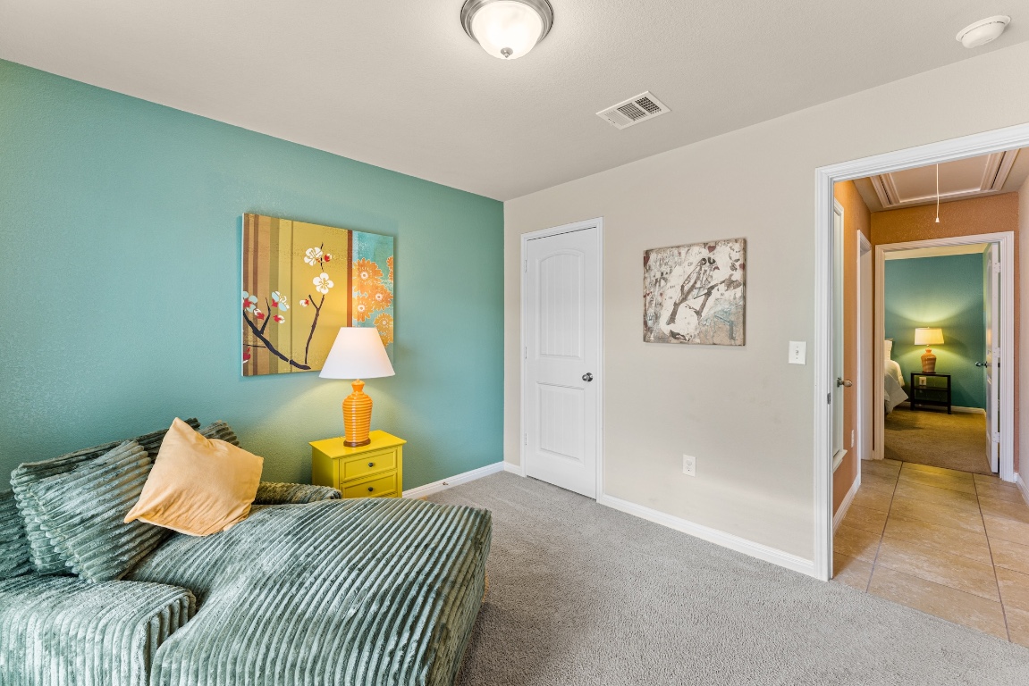 408 Cane River Road Pflugerville, TX 78660 - Photo 29 of 38 a bedroom with a bed and painting on the wall