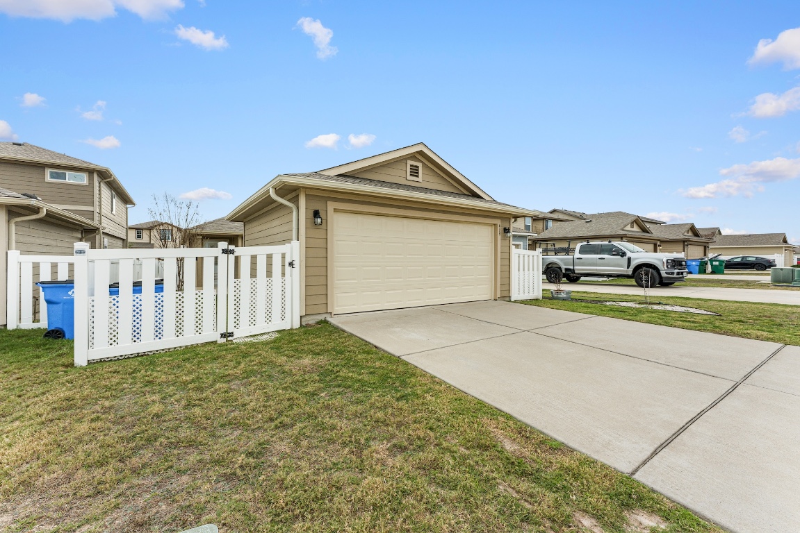 408 Cane River Road Pflugerville, TX 78660 - Photo 35 of 38 a view of a house with a yard and garage