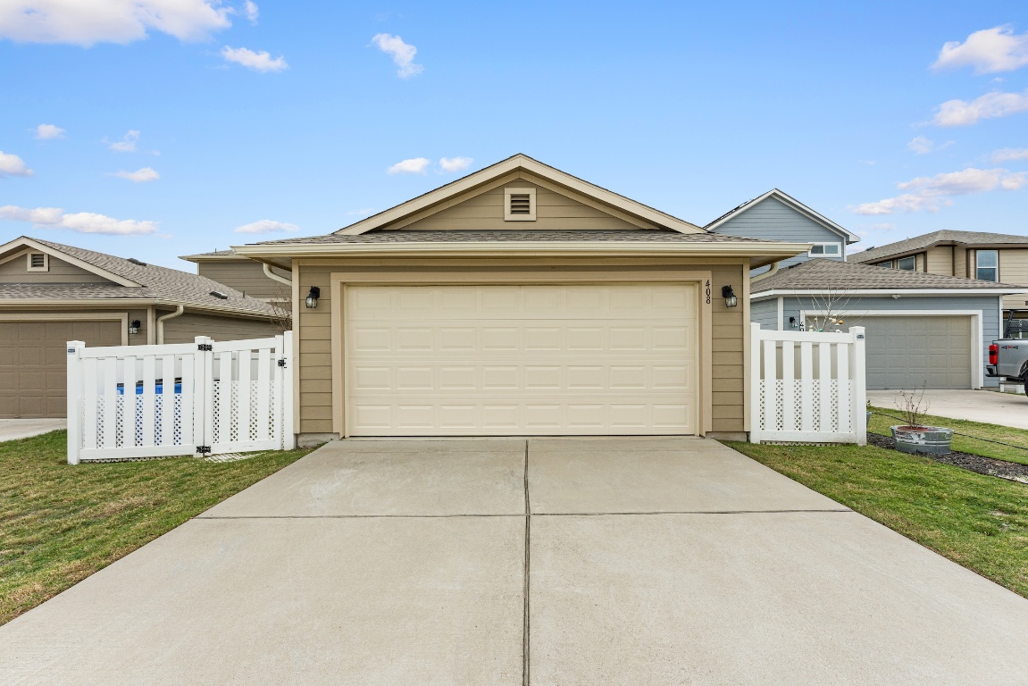 408 Cane River Road Pflugerville, TX 78660 - Photo 36 of 38 a front view of a house with a yard and garage