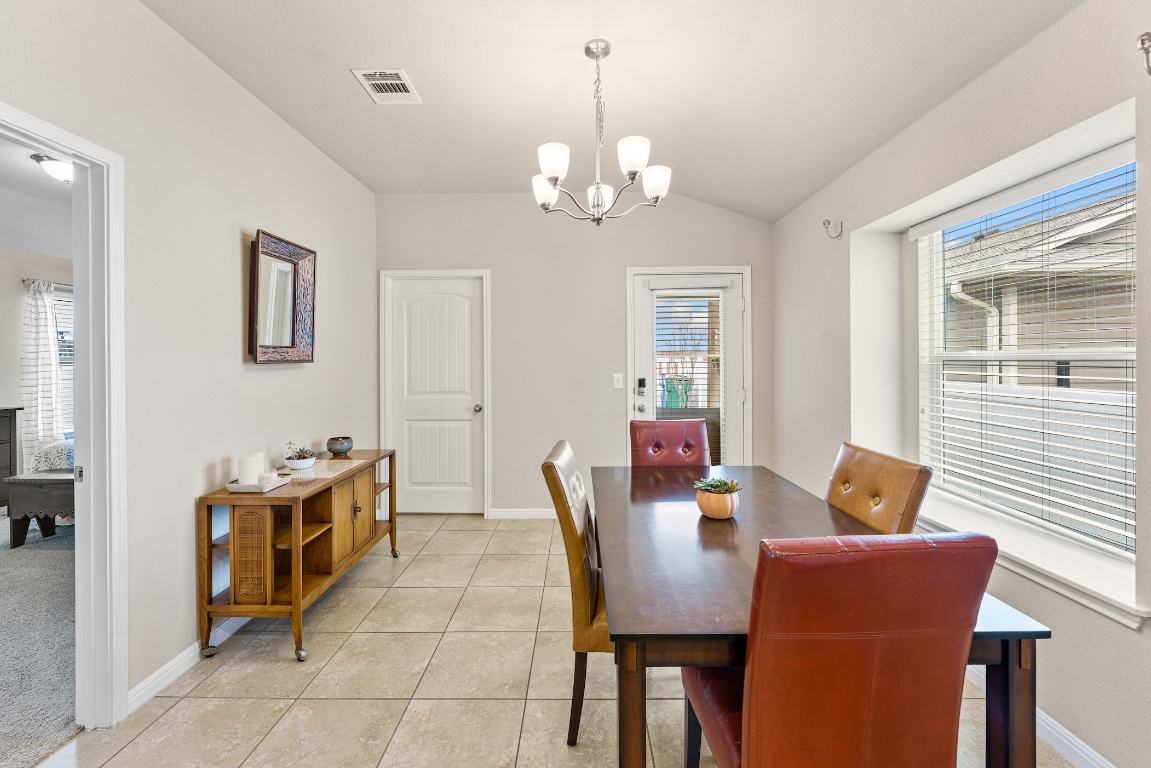 408 Cane River Road Pflugerville, TX 78660 - Photo 8 of 38 a dining room with furniture and chandelier