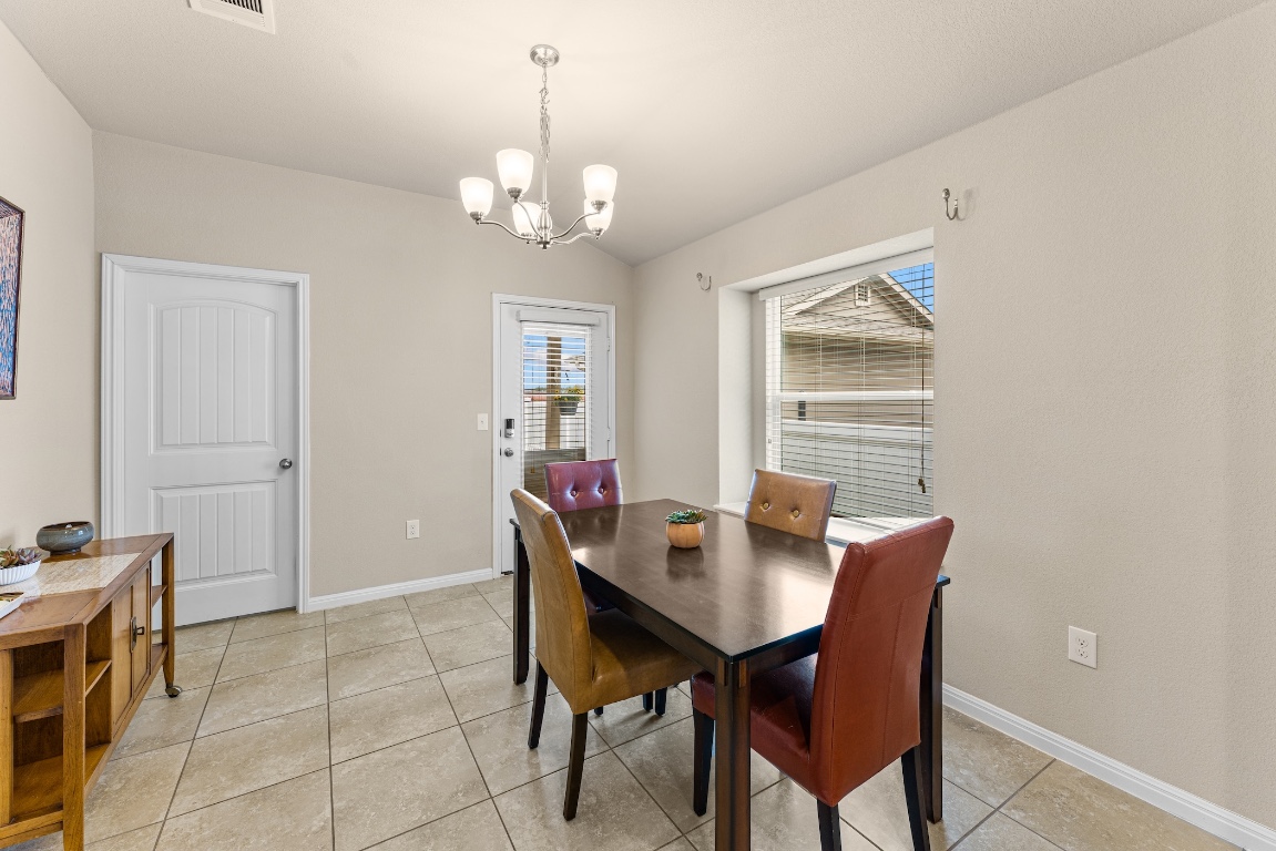 408 Cane River Road Pflugerville, TX 78660 - Photo 9 of 38 a view of a dining room with furniture and window