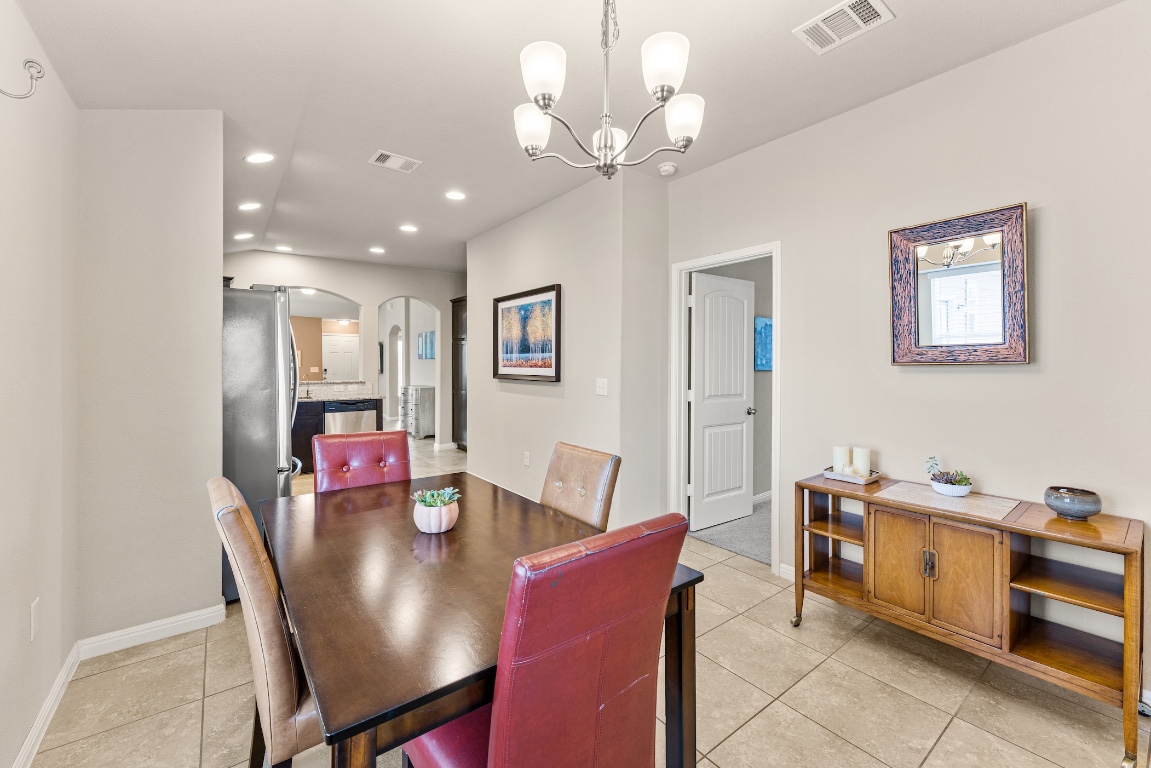 408 Cane River Road Pflugerville, TX 78660 - Photo 10 of 38 a view of a dining room with furniture and chandelier