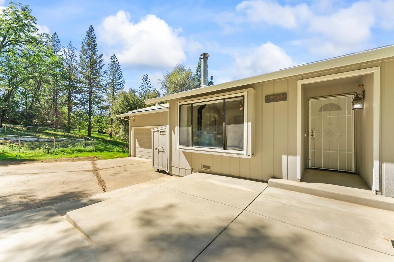 4705 Sand Ridge Road Placerville, CA 95667 - Photo 34 of 36 a front view of a house with a yard and garage