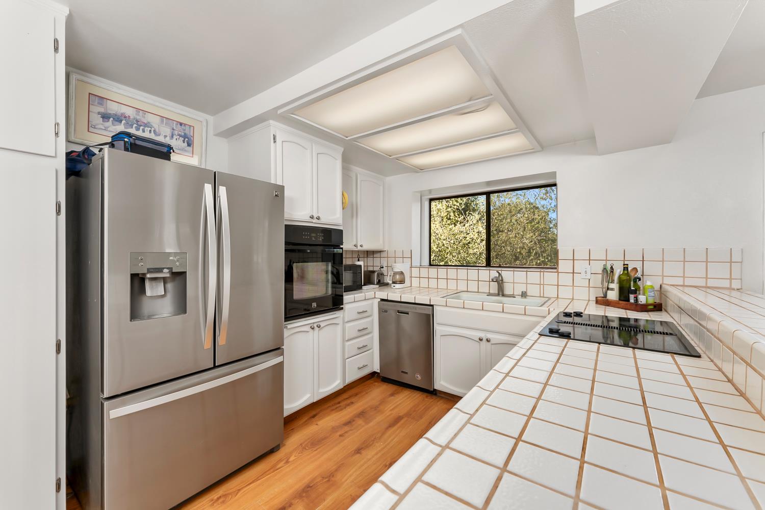 4705 Sand Ridge Road Placerville, CA 95667 - Photo 5 of 36 a kitchen with a refrigerator a stove top oven and sink