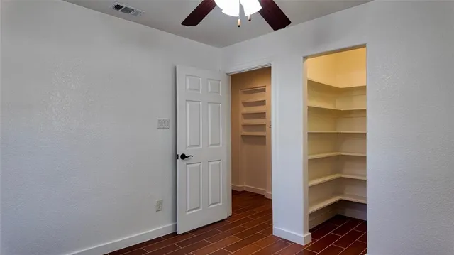 a view of walk in closet with empty racks