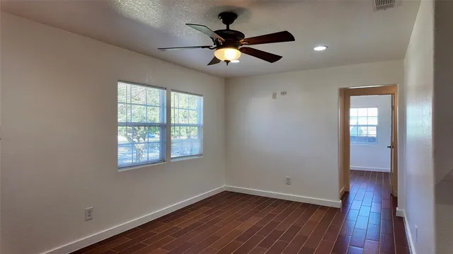 wooden floor in an empty room with a window